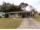 Tan single story home with carport and small yard at 435 92Nd N Ave, St Petersburg, FL 33702