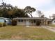 Tan single story home with carport and small yard at 435 92Nd N Ave, St Petersburg, FL 33702