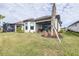 Spacious backyard offering privacy and a view of the screened patio at 4639 Garofalo Rd, Wesley Chapel, FL 33543