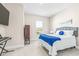 Spacious bedroom featuring a comfortable bed, large window, and TV at 4639 Garofalo Rd, Wesley Chapel, FL 33543