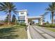 Gated entrance to community with palm trees and paved road at 4639 Garofalo Rd, Wesley Chapel, FL 33543