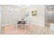 Bright dining room with chandelier and pink rug at 4639 Garofalo Rd, Wesley Chapel, FL 33543