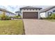 House exterior showcasing a brown garage door and paved driveway at 4639 Garofalo Rd, Wesley Chapel, FL 33543