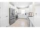 Modern kitchen with stainless steel appliances and white cabinets at 4639 Garofalo Rd, Wesley Chapel, FL 33543