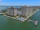 Aerial view of waterfront condo building with pool and boat docks at 5220 Brittany S Dr # 201, St Petersburg, FL 33715