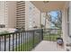 Private balcony overlooking a parking lot and landscaped area at 5220 Brittany S Dr # 201, St Petersburg, FL 33715