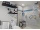 Updated bathroom with walk-in shower, grab bars, and floating shelves at 5220 Brittany S Dr # 201, St Petersburg, FL 33715