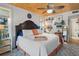 Main bedroom with king bed, wood ceiling, and access to bathroom at 5220 Brittany S Dr # 201, St Petersburg, FL 33715