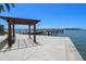 Relaxing waterfront dock area with pergola and seating at 5220 Brittany S Dr # 201, St Petersburg, FL 33715