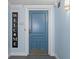 Light blue condo entry with blue door and welcome sign at 5220 Brittany S Dr # 201, St Petersburg, FL 33715