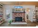 Brick fireplace with TV above in living room at 5220 Brittany S Dr # 201, St Petersburg, FL 33715