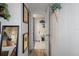 Hallway leading to bathroom, with wood flooring and wall art at 5220 Brittany S Dr # 201, St Petersburg, FL 33715