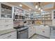 Well-equipped kitchen featuring white cabinets and a farmhouse sink at 5220 Brittany S Dr # 201, St Petersburg, FL 33715