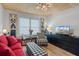 Cozy living room featuring red sofa, plaid armchair, and wood floors at 5220 Brittany S Dr # 201, St Petersburg, FL 33715