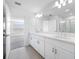 Double vanity bathroom with a large mirror and shower at 5913 Laurelcrest Gln, Palmetto, FL 34221
