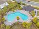 Community pool with surrounding lounge chairs at 5913 Laurelcrest Gln, Palmetto, FL 34221