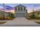 Two-story house with gray siding, two-car garage, and landscaping at 5913 Laurelcrest Gln, Palmetto, FL 34221