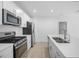 Modern kitchen with white cabinets and stainless steel appliances at 5913 Laurelcrest Gln, Palmetto, FL 34221