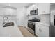 Modern kitchen with white cabinets and stainless steel appliances at 5913 Laurelcrest Gln, Palmetto, FL 34221