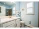 Bathroom with single vanity, toilet, and window with plantation shutters at 5914 Fiore Dr, Bradenton, FL 34208