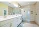 Bathroom with double vanity, large shower, and neutral tile at 5914 Fiore Dr, Bradenton, FL 34208