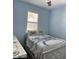 Light blue bedroom with a crab bedding set and white dresser at 5914 Fiore Dr, Bradenton, FL 34208