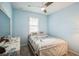 Light blue bedroom with full bed and window with plantation shutters at 5914 Fiore Dr, Bradenton, FL 34208