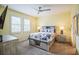 Bedroom with queen bed, light gray dresser, and window with plantation shutters at 5914 Fiore Dr, Bradenton, FL 34208