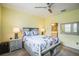 Bedroom with queen bed, light wood nightstands, and an en-suite bathroom at 5914 Fiore Dr, Bradenton, FL 34208