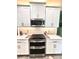 Modern kitchen with stainless steel appliances and white cabinets at 5914 Fiore Dr, Bradenton, FL 34208