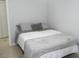 Cozy bedroom with a double bed and gray bedding at 6033 34Th W St # 45, Bradenton, FL 34210