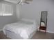 Bedroom with ceiling fan, window and mirror at 6033 34Th W St # 45, Bradenton, FL 34210