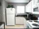 White appliances and cabinets, black countertops, and a breakfast bar at 6033 34Th W St # 45, Bradenton, FL 34210
