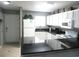 Modern kitchen with white cabinets, black countertops, and stainless steel appliances at 6033 34Th W St # 45, Bradenton, FL 34210