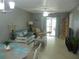 Spacious living room with light teal couch and sliding glass doors to patio at 6033 34Th W St # 45, Bradenton, FL 34210