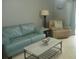 Living room features a teal couch, recliner, and coffee table at 6033 34Th W St # 45, Bradenton, FL 34210