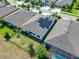 Aerial view of a house with solar panels and a backyard at 6442 Maiden Sea Dr, Apollo Beach, FL 33572