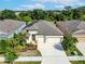 House with solar panels, two-car garage, and landscaping at 6442 Maiden Sea Dr, Apollo Beach, FL 33572