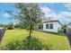 Spacious backyard with grassy area, tree, and fence at 6442 Maiden Sea Dr, Apollo Beach, FL 33572