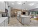 Spacious kitchen with island, stainless steel appliances, and wood feature wall at 6442 Maiden Sea Dr, Apollo Beach, FL 33572