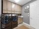 Laundry room with modern washer, dryer, and cabinets at 6442 Maiden Sea Dr, Apollo Beach, FL 33572