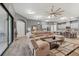 Open living space with sectional sofa and views to kitchen and dining areas at 6442 Maiden Sea Dr, Apollo Beach, FL 33572