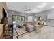 Open concept living room with sectional sofa and view of kitchen and dining area at 6442 Maiden Sea Dr, Apollo Beach, FL 33572