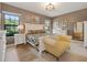 Main bedroom with plush bed, seating area, and large windows at 6442 Maiden Sea Dr, Apollo Beach, FL 33572