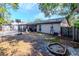 Backyard view showing a basketball hoop and fire pit at 7028 Oakview Cir, Tampa, FL 33634