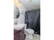 Clean bathroom with dark vanity and shower at 7028 Oakview Cir, Tampa, FL 33634