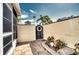 Private backyard with stone patio and access gate at 744 Cadiz Rd # 1, Venice, FL 34285
