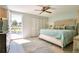 Bright main bedroom with king-size bed and sliding door to balcony at 744 Cadiz Rd # 1, Venice, FL 34285