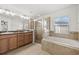 Bathroom with double vanity, shower, and garden tub at 8123 Rothbury Hills Pl, Gibsonton, FL 33534