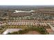 Aerial view of houses in a residential community by a lake at 8424 Alberata Vista Dr, Tampa, FL 33647